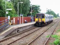 The new, staggered, up platform at Langho is seen from the down side as 150272 heading for Manchester climbs away up the bank, out of the Ribble Valley and towards the summit at Wilpshire tunnel.<br><br>[Mark Bartlett 17/07/2008]