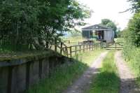 View from the end of the platform of the former Nisbet station (1856-1948) looking south along the trackbed towards the terminus at Jedburgh in the summer of 2008. Note the surviving goods platform on the east side of the line beyond the gate. [See image 33141]<br><br>[John Furnevel 01/07/2008]