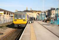 A train for Bishop Auckland via Darlington stands at platform 1 at Saltburn station on 3 April 2008. The former Stockton & Darlington station building can be seen beyond the end of the current platforms. [See image 17868]<br><br>[John Furnevel 03/04/2008]