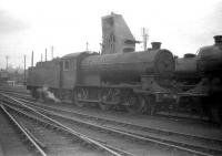 Class J38 0-6-0 65924 stands in front of the ash handling plant at Dunfermline shed in May 1959. Note the signal post in the background protruding above the roof of the cab. This signal is located on the embankment that carried the line to Dunfermline Upper station.<br><br>[Robin Barbour Collection (Courtesy Bruce McCartney) 19/05/1959]
