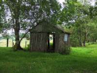 Approaching the Half way point and a platelayers hut still stands  43 years after the line closed.It is built from railway sleepers and one wall is down.<br><br>[John Gray 23/07/2008]