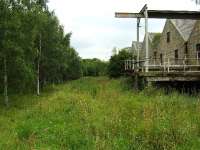 The railway ran along the side of this distillery building and barrels were probably loaded onto wagons using the hoist on the right.<br><br>[John Gray 26/07/2008]