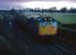 Dawn struggles to break in December 1985 as a train of molasses bound for Menstrie leaves Alloa marshalling yard. The yard was closed two years later when a new run around loop was installed at Cambus<br><br>[Mark Dufton /12/1985]