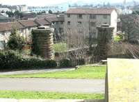 Straight on for Leith! The surviving pair of piers which carried the Caledonian 'Leith New Lines' across the rooftops towards Leith's Eastern Docks. The photograph is taken looking south east from the bridge abutment at the bottom of Gosford Place [see image 26704] in March 2003 with the site of the Caledonian's Ferry Road station (which never opened) behind the camera. Below is the trackbed of the NB line from Bonnington East Jct to Warriston Jct and, just beyond that, the line to Bonnington South Jct. <br><br>[John Furnevel 10/03/2003]