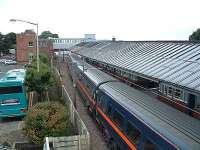 GNER train stops in southbound platform. Connection bus waits.<br><br>[Ewan Crawford //]