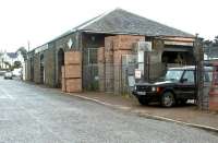 The substantial old goods shed at Castle Douglas, seen here in July 2002 put to use by a builders merchant.<br><br>[John Furnevel 15/07/2002]