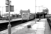 Platform view west at Southall on 18 November 1980 as a train of tanks runs through the station.<br><br>[John Furnevel 18/11/1980]