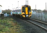 A 158 from Edinburgh leaves the original through route at Bathgate  in December 2004 and turns onto the short spur leading to the 1986 terminus. In the background is the STVA car compound.<br><br>[John Furnevel 29/12/2004]
