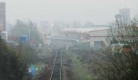 Kilmarnock station and the junction between the Troon (right)and Barrhead (centre) lines seen from the north. The line to Dalry occupied the overgrown ground on the right and is still partly intact. On the left a siding leads to a distillery.<br><br>[Ewan Crawford 03/04/2005]