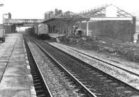 A freight heads north through Lockerbie on the WCML in February 1972. Demolition work is underway on the former Dumfries branch platforms and trainshed as part of the refurbishment of Lockerbie station undertaken in advance of electrification.<br><br>[John Furnevel 13/02/1972]