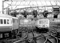 Looking south across the Clyde from Glasgow Central on 18 August 1981. A London train is leaving on the left while in the centre 311105 heads for Kirkhill. <br><br>[John Furnevel 18/08/1981]