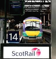 A ScotRail shuttle service for Glasgow Queen Street awaits its departure time at Edinburgh Waverley platform 14 in December 2002.<br><br>[John Furnevel 11/12/2002]