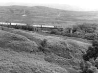 A Fort William - Glasgow Queen Street train on the approach to Garelochhead in June 1971.<br><br>[John Furnevel 29/06/1971]