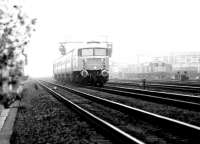 On 18 April 1980 a Glasgow - Edinburgh push-pull service emerges from the fog as it passes Haymarket MPD. The locomotive is 47707 <I>Holyrood</I>.<br><br>[John Furnevel 18/04/1980]