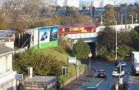 66184 takes an Eastbound coal train over Slateford Road and through Slateford station in October 2002. The train will leave the main line at Slateford Junction immediately after the station and turn south to join the 'sub' at Craiglockhart Junction. <br><br>[John Furnevel 26/10/2002]