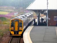 158 705 at the rear of a five car train stops at Leuchars northbound on 28 July, with Willow Herb covering the former goods sidings.<br><br>[Brian Forbes 28/07/2008]