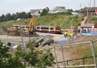 A Bathgate - Newcraighall service runs into Livingston North station on 25 July 2008. Photographed from the <I>unofficial path</I> that currently leads from the south side car park up to Deans Road bridge.<br><br>[John Furnevel 25/07/2008]