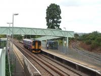 A Worcester to Swindon direct service formed of 153305 calls at Ashchurch. The former Evesham line, closed in 1963, is now a siding into Ashchurch MOD Depot and can be seen trailing in from the right. The station itself closed in 1971 but reopened in 1997. <br><br>[Mark Bartlett 30/07/2008]