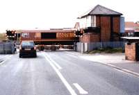 EWS 66076 rumbles south over Marchey's House level crossing towards Bedlington Station on 25 May 2004 with a train of empties from Lynemouth. <br><br>[John Furnevel 25/05/2004]