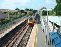 The old water tower at Ashchurch can be seen beyond the station platform but all other infrastructure associated with the Tewkesbury branch line that diverged west here has been built over. The Voyager has just passed the goods loop on its way from Birmingham towards Bristol.<br><br>[Mark Bartlett 27/07/2008]