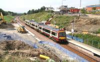 View west from the road bridge over Livingston North station showing progress on 25 July, with a Bathgate - Newcraighall service at the platform.<br><br>[John Furnevel 25/07/2008]