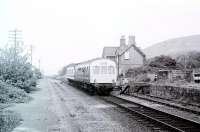 A Met Cam 101 DMU in hybrid livery calls at Llwyngwril on a Pwllheli service in May 1980. The passing loop had been removed by this time. Judging by the arm waving this was a school service. View north towards Barmouth. <br><br>[Mark Bartlett /05/1980]