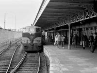 Standing on the south shore of the Great Island in Cork Harbour, Cobh has a frequent train service to and from Cork city. CIE 158 is seen shortly after arriving with a terminating service at Cobh station in 1988. [See image 27139]<br><br>[Bill Roberton //1988]