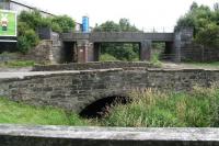 The bridge in the background stands alongside the B7002 Whitburn Road in Bathgate. It is located just north of the former Polkemmet Junction and carried the line from Bathgate Upper station over a burn and on towards Armadale. The bridge is now part of a walkway/cycle route and still looks in remarkably good condition...which is more than can be said for the adjacent road bridge. <br><br>[John Furnevel 31/07/2008]