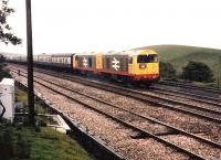 A pair of Railfreight liveried Class 20s, led by 20104, on a railtour in the pouring rain at Blea Moor on the Settle and Carlisle line circa 1985.<br><br>[Colin Alexander //1985]