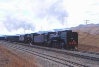 QJ7012+6687 hauling freight at Shangdian on the Ji-Tong Railway, Inner Mongolia, in April 2000.<br><br>[Peter Todd /04/2000]