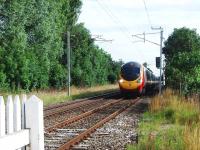 All trace of Bolton-le-Sands station was swept away between closure in 1969 and electrification in 1974. Here a Pendolino passes the site of the old platforms and approaches the level crossing at speed from Carnforth on a southbound service. View north from the level crossing. Map Ref SD480683<br><br>[Mark Bartlett 05/08/2008]