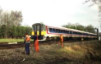 <I>Its not the digging that wears me out, its more the constant waving...</I> A Waterloo to Bournemouth service comprised of two 5 car class 442 sets passes a PW gang between Hook and Basingstoke in February 1992.<br><br>[John McIntyre 26/02/1992]