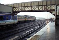 Looking towards the buffer stops and Loch Ryan at Stranraer Harbour station early in the morning of 28 April 1990. The class 47 has recently arrived with the sleeper from Euston, while the 156 awaits a return trip to Glasgow.<br><br>[John McIntyre 28/04/1990]