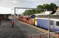 Scene at Carstairs at 6.25am on a pleasant Tuesday morning in the Summer of 2006. The 15 coach Caledonian Sleeper from Euston arrived 11 minutes earlier behind EWS 90022. The train has been split and 90022 is about to continue its journey to Glasgow Central with what is now an 8 coach train. Meantime 37405 has been coupled up to the other end and is preparing to depart with the rear 7 coaches for Edinburgh Waverley.<br><br>[John Furnevel 11/07/2006]