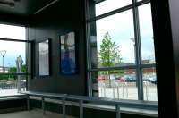 A look inside the station shelter at Alloa, showing the metal sculpture and car park beyond.<br><br>[Brian Forbes 30/05/2008]