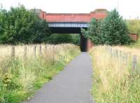 Looking north along the trackbed of the former North British Railway freight only branch from the Seafield Oil Works near Blackburn, West Lothian, about to pass below this substantial bridge carrying the A7066 road over the line near the Boghall roundabout. Approximately 100 yards beyond the bridge the branch joined the Edinburgh & Bathgate Railway westbound at Bathgate East Junction. The branch closed in 1955 and the trackbed is now a walkway/cycleway. [See image 20270] <br><br>[John Furnevel 14/08/2008]