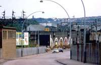 Looking down South College Street, Aberdeen, in July 1974, as a class 40 heads south away from the station on its way to Ferryhill MPD. Under the arches is a series of small <I>factories</I> handling the filleting and preparation of locally landed fish, with stacks of empty fish boxes in evidence alongside ready for return to the harbour.<br>
<br>
<br><br>[John McIntyre /07/1974]