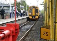 View from the buffer stops at Bathgate as 158705 runs into the terminus at 1320 (according to the station clock) on 19 August 2008 with the 1248 from Waverley. The train will depart 5 minutes later as the 1325 <I>Crossrail</I> service to Newcraighall. The floodlighting tower directly behind the train is part of the STVA Bathgate car terminal.<br><br>[John Furnevel 19/08/2008]