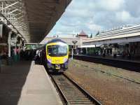 A Trans Pennine service for Blackpool with 185144 picks up a sizeable number of passengers under an original canopy at Bolton <I>Trinity Street</I> on 13 August 2008. At this time services to Preston and beyond were running via Wigan because of engineering work at Chorley. Just beyond the bridge the line divides with a right turn for Blackburn and left for Lostock Junction. <br><br>[Mark Bartlett 13/08/2008]