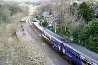 An afternoon Northern Rail service from Middlesbrough to Whitby runs into Sleights on 3 April 2008. The main station buildings on the retained down platform, including the station masters house, are now part of a substantial private residence, while the former wooden <I>waiting shed</I> and store from the abandoned up platform, having been rescued by the NYMR, now adorn the down side at Grosmont station. The old brick signal box on the left beyond the foot crossing (leading to a footbridge over the River Esk off to the left) is gradually returning to nature.<br><br>[John Furnevel 03/04/2008]