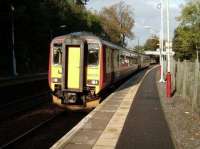 A morning train for East Kilbride pulls into Thornliebank under a low autumn sun on 13 October 2007. Unit 156 439.<br><br>[David Panton 13/10/2007]