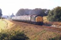 40084, returning from Blackpool North between Kirkham and Salwick with yet another long Saturdays Only train on the busy August Bank Holiday weekend of 1982. This was the last summer of passenger working for 40084 as it was withdrawn the following May and cut up at Crewe a year later. Map Ref SD 446325 <br><br>[Mark Bartlett 28/08/1982]