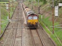 Awaiting the call to move into the working area, 66248 sits in the WCML cutting north of the Oubeck loops with an infrastructure train during a relaying possession. The signal to the right of the locomotive normally controls access into the Up Loop. Map Ref SD 490575<br><br>[Mark Bartlett 17/05/2008]