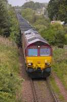 EWS 66082 brings empty coal hoppers east from Longannet on 25 August, passing the site of Cairneyhill station in the right background.<br><br>[Bill Roberton 25/08/2008]