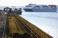 The Stena Seacat ferry service from Belfast prepares to dock at Stranraer Harbour on 29 July 2008, while a First Scotrail 156 DMU awaits passengers at the station platform.<br><br>[Bill Roberton 29/07/2008]