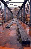 Looking north over the Creagan Viaduct. The timbers which supported the rails were still in place as was the walkway down the right (east) side of the line. This bridge has been demolished and rebuilt as a road bridge thus saving the motorist from an inland journey.<br><br>[Ewan Crawford //1990]