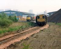 An 08 and a 37 shunt at Deanside Transit. The large embankment to the right (long gone) used to provide a marvellous view. The view looks to Cardonald. The site of Deanside station (now a rounding loop) is some way behind the camera.<br><br>[Ewan Crawford //1989]