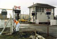 Ardrossan Harbour box on its last day. Oddly this box was left out of the Ayrshire resignalling for a short while. The level crossing was receiving some final attention. By the end the box contained an almost completely white (redundant) lever frame. The (nearly) Trotters Independent Traders van in the background is a BR vehicle of the time.<br><br>[Ewan Crawford //1989]