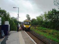 A Windermere train approaches Staveley from the south and passes the station entrance. The former down platform can be seen to the right of Pennine unit 185146.  <br><br>[Mark Bartlett 30/08/2008]