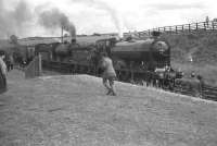 Preserved ex-NBR no 256 <i>Glen Douglas</i>, together with J37 no 64624 photographed at the head of the <I>RCTS Borders Rail Tour</I> which ran from Leeds City on Sunday 9 July 1961 and is seen here at Greenlaw, Berwickshire.<br><br>[Robin Barbour Collection (Courtesy Bruce McCartney) 09/06/1961]